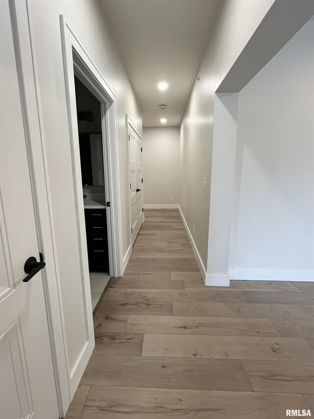 corridor with light wood-type flooring