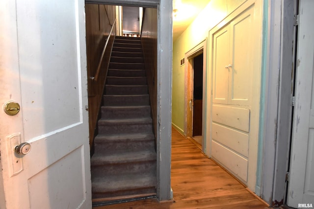 stairs with hardwood / wood-style flooring