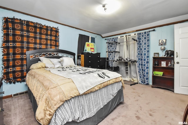 carpeted bedroom with ornamental molding