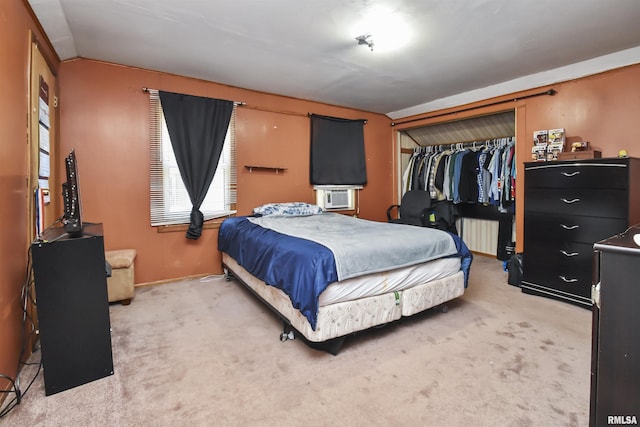 bedroom featuring carpet flooring, a closet, and lofted ceiling