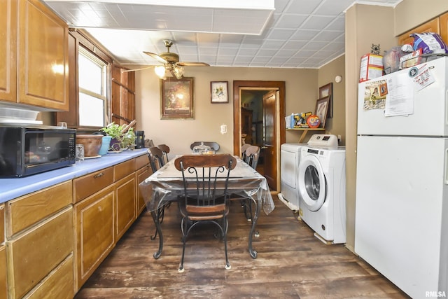 kitchen featuring ceiling fan, white fridge, washing machine and dryer, and dark wood-type flooring