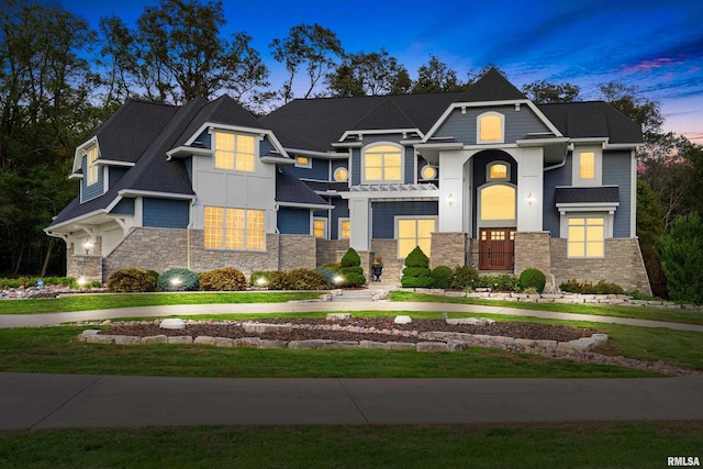 view of front of property featuring stone siding and a front yard