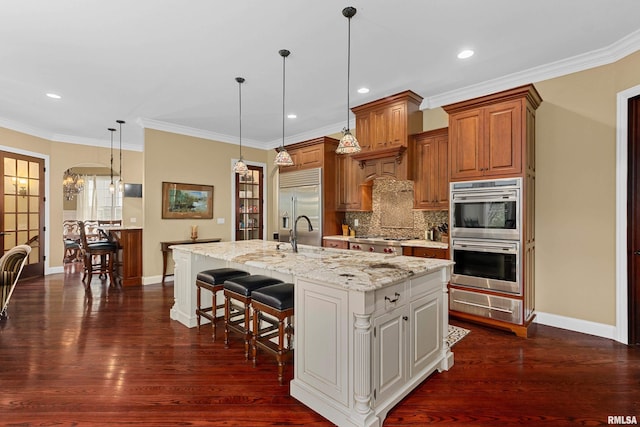 kitchen featuring backsplash, baseboards, stainless steel appliances, and dark wood-type flooring