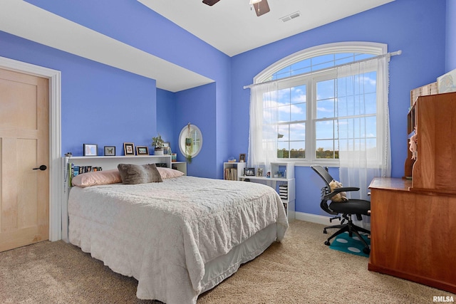 carpeted bedroom with baseboards, visible vents, and ceiling fan