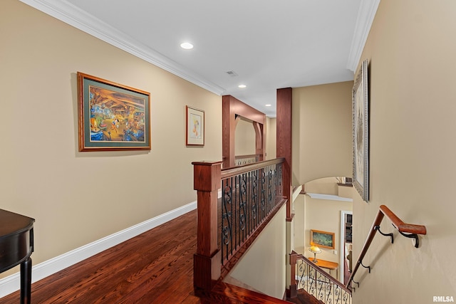 hallway featuring crown molding, wood finished floors, an upstairs landing, baseboards, and recessed lighting