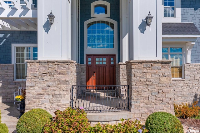 doorway to property featuring stone siding