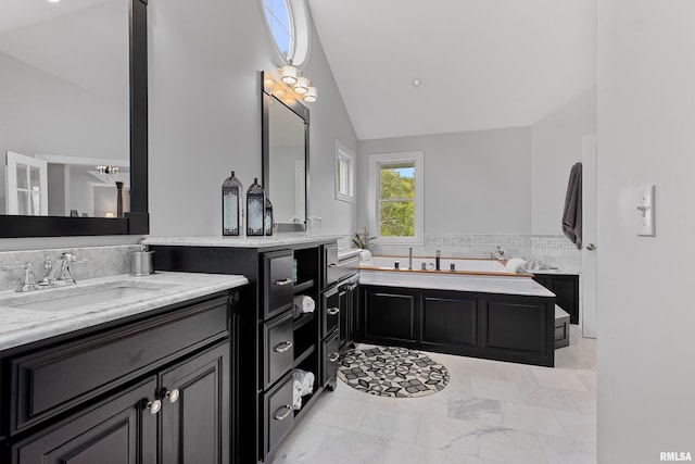 bathroom featuring a bath, backsplash, marble finish floor, vanity, and high vaulted ceiling