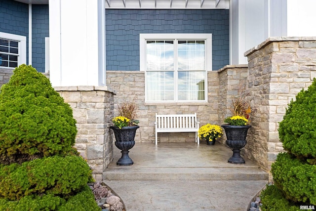 entrance to property with stone siding
