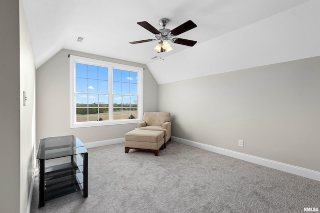living area featuring ceiling fan, lofted ceiling, baseboards, and carpet