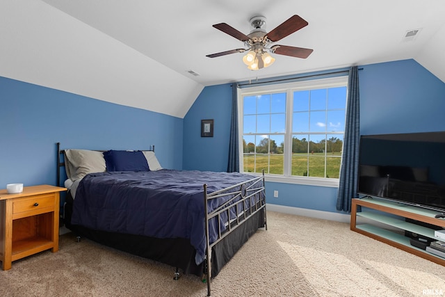 bedroom with lofted ceiling, baseboards, visible vents, and carpet floors