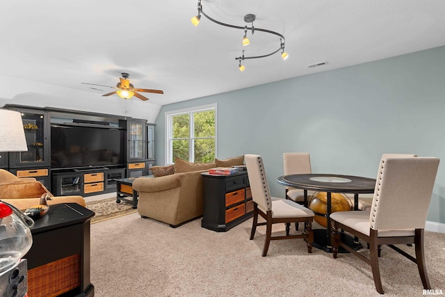 living room with visible vents, a ceiling fan, and light colored carpet