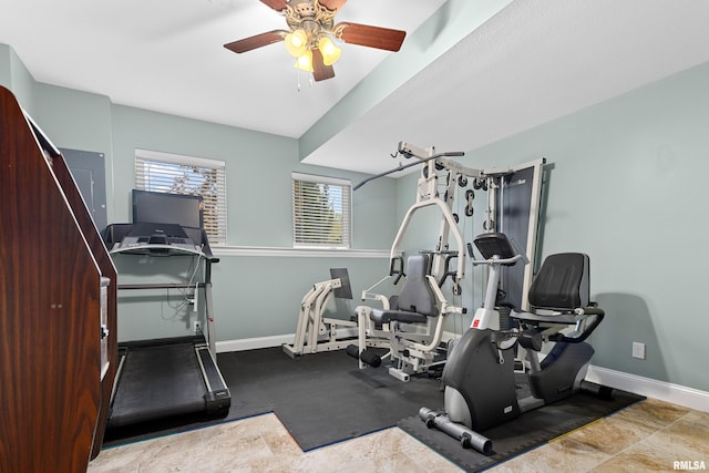 exercise area with a ceiling fan and baseboards