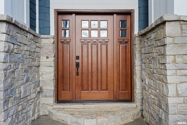 entrance to property with stone siding
