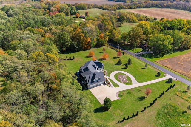 birds eye view of property featuring a wooded view