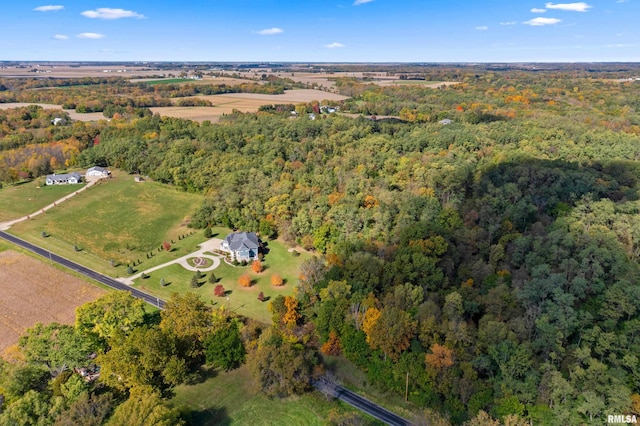 drone / aerial view featuring a forest view