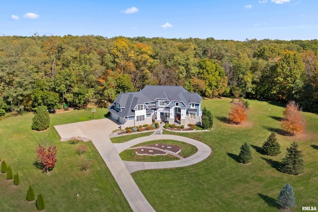 birds eye view of property with a wooded view