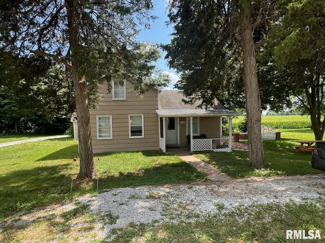 view of front of home featuring a front lawn and covered porch