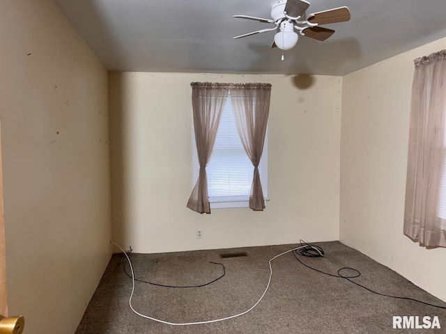 carpeted spare room with ceiling fan