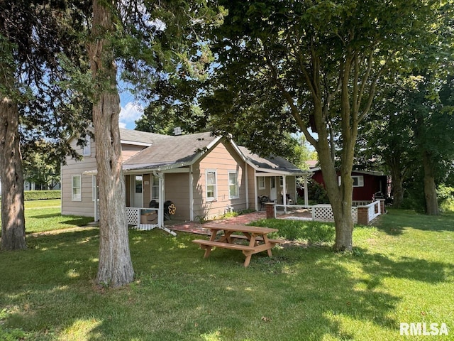 rear view of property with a yard