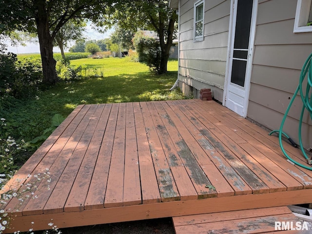 wooden terrace featuring a lawn