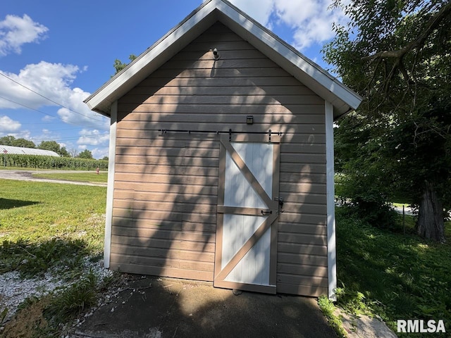 view of outbuilding with a lawn