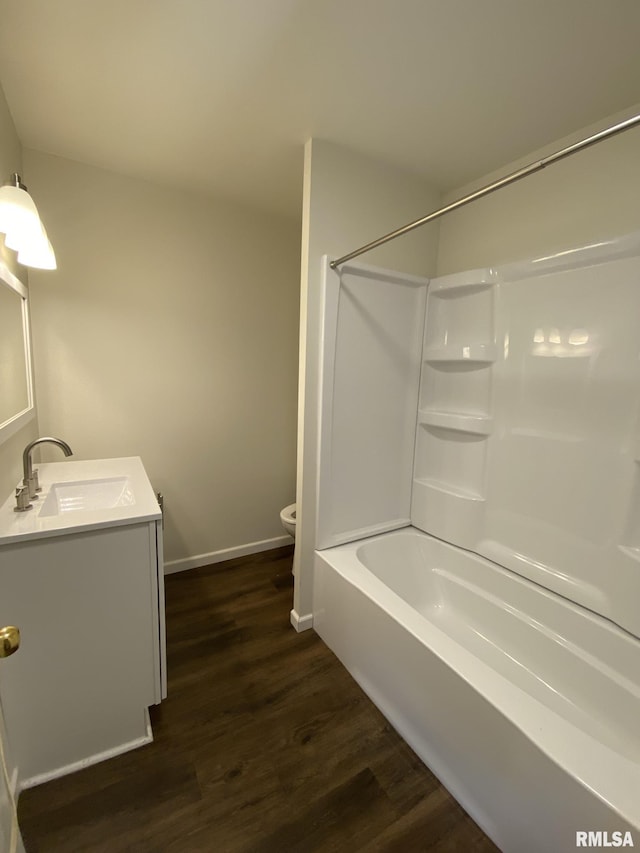 full bathroom featuring vanity, wood-type flooring, shower / tub combination, and toilet