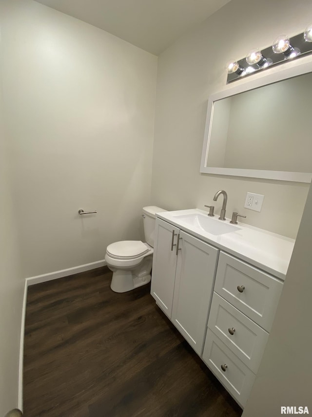 bathroom with vanity, hardwood / wood-style floors, and toilet