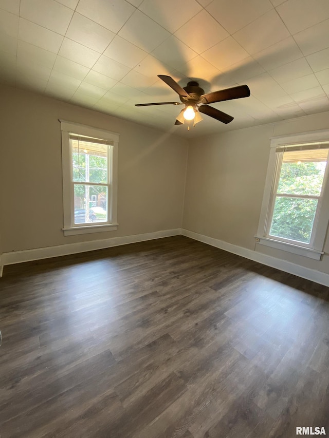 unfurnished room featuring dark hardwood / wood-style floors and ceiling fan