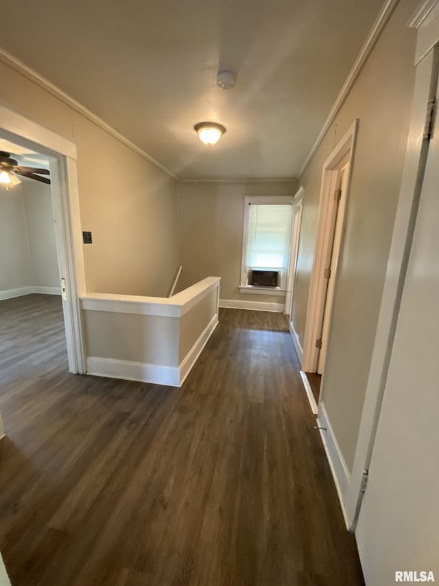 hallway with dark hardwood / wood-style flooring and ornamental molding