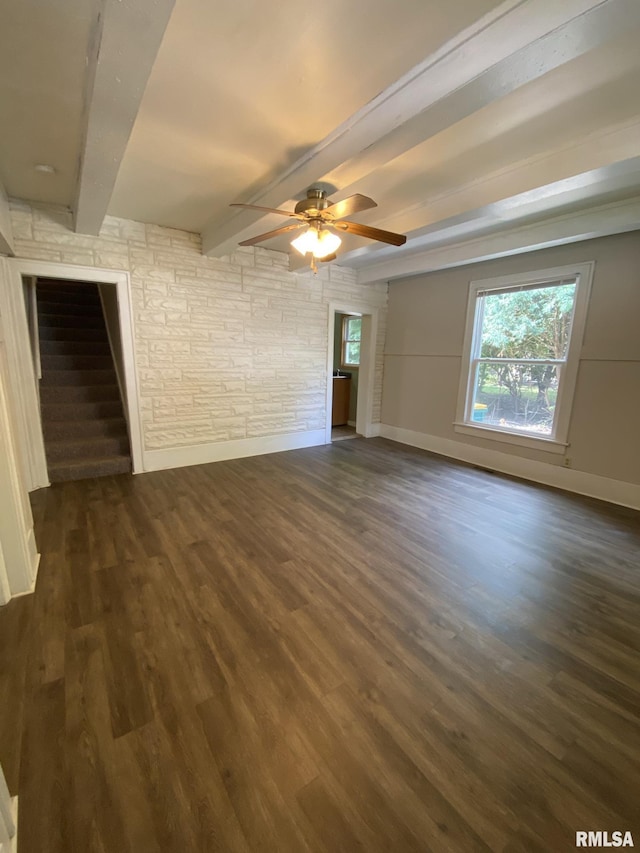 unfurnished room with beamed ceiling, ceiling fan, and dark hardwood / wood-style floors