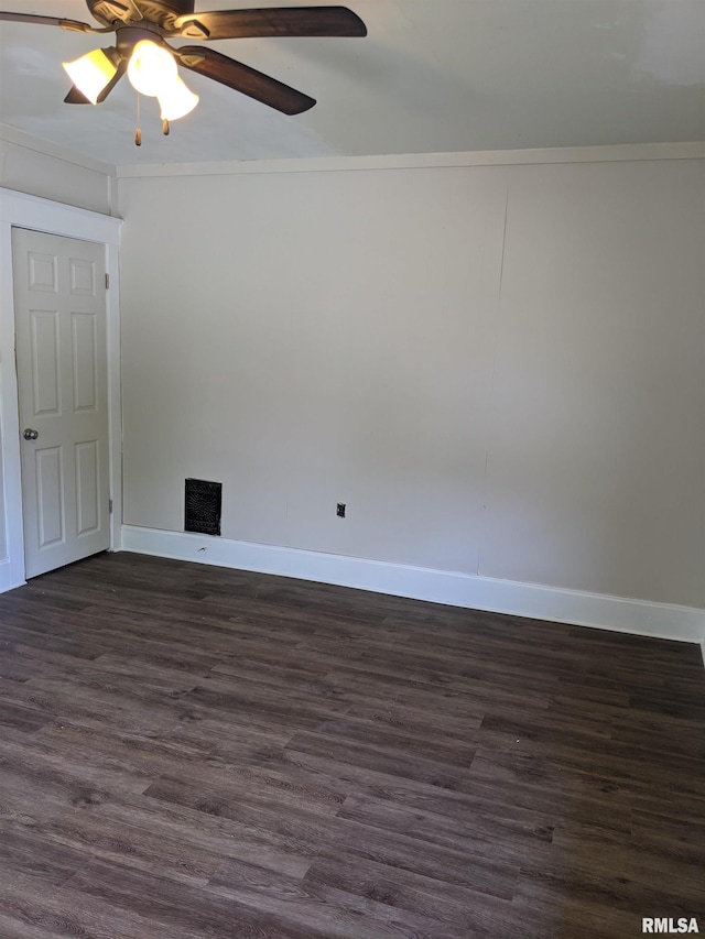 empty room with crown molding, dark wood-type flooring, and ceiling fan