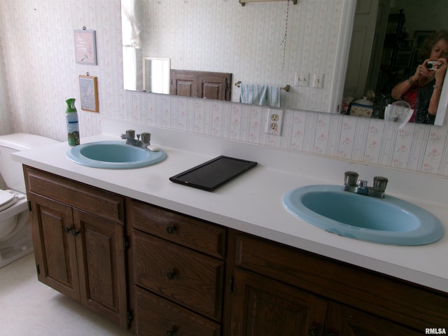 bathroom featuring vanity and toilet