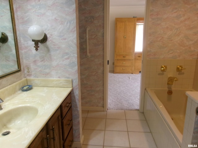 bathroom featuring tile patterned flooring, vanity, and a tub