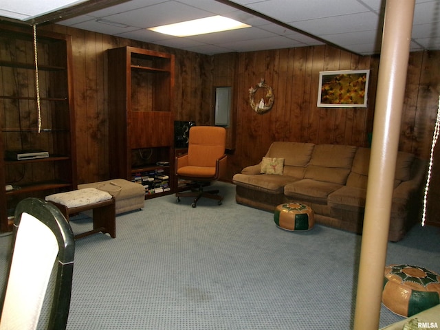 living room featuring carpet and wooden walls