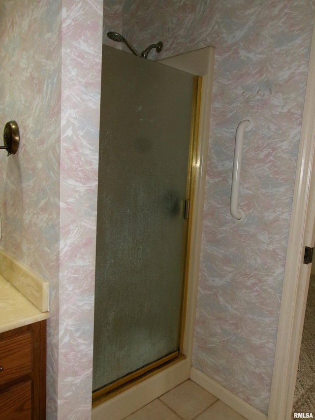 bathroom featuring an enclosed shower and tile patterned flooring