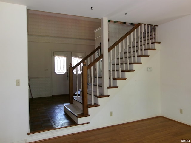 staircase with hardwood / wood-style floors