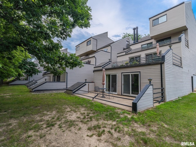 back of property with a patio and a lawn