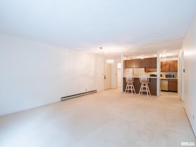 unfurnished living room featuring baseboard heating, an inviting chandelier, and light colored carpet