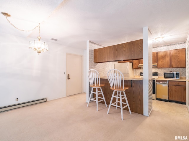 kitchen featuring white appliances, a breakfast bar, hanging light fixtures, ventilation hood, and a baseboard radiator