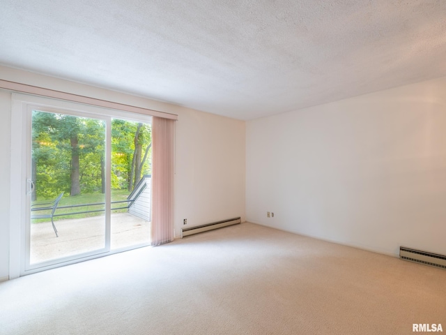 empty room with light carpet, a baseboard heating unit, and a textured ceiling