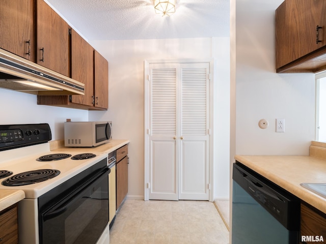 kitchen featuring appliances with stainless steel finishes, brown cabinets, light countertops, a textured ceiling, and under cabinet range hood