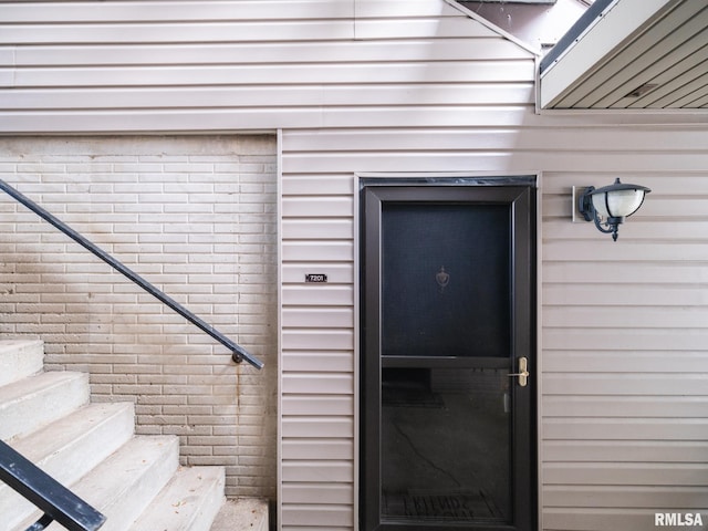 doorway to property with brick siding