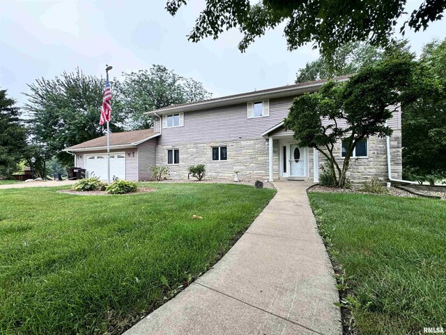 front of property featuring a garage and a front yard