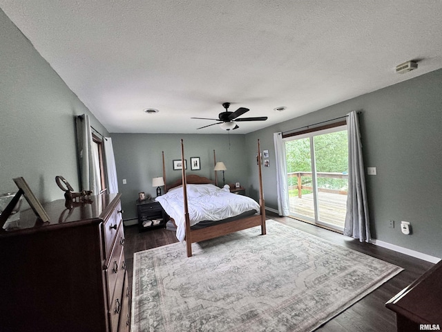 bedroom with dark wood-style floors, baseboards, a baseboard radiator, a textured ceiling, and access to outside