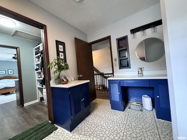 bathroom featuring a textured ceiling, vanity, ensuite bathroom, and wood finished floors