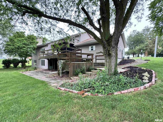 exterior space with a deck and a lawn