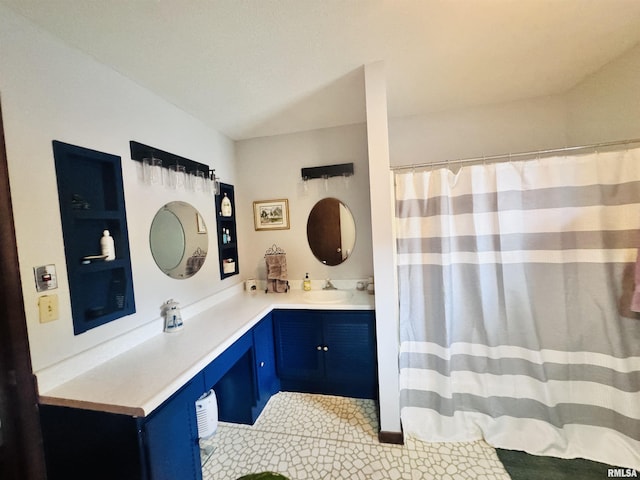 bathroom with a shower with curtain and vanity