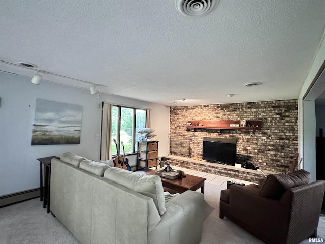 living area featuring visible vents, a fireplace, a textured ceiling, and rail lighting