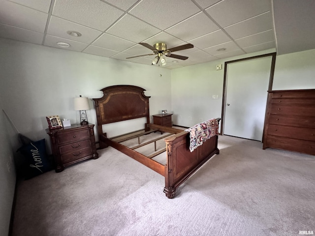 carpeted bedroom featuring a paneled ceiling and ceiling fan