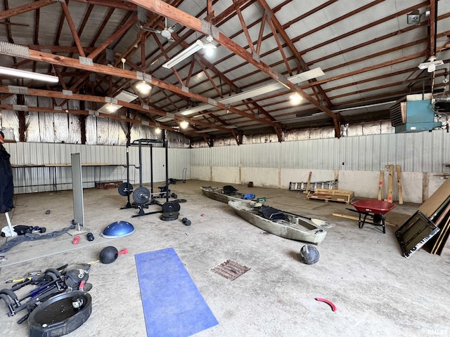 workout room with metal wall, a garage, and vaulted ceiling